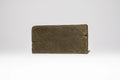 Single block of Afghan Charas 50% THCA hash on a light background, showing the smooth pressed surface and compact shape.
