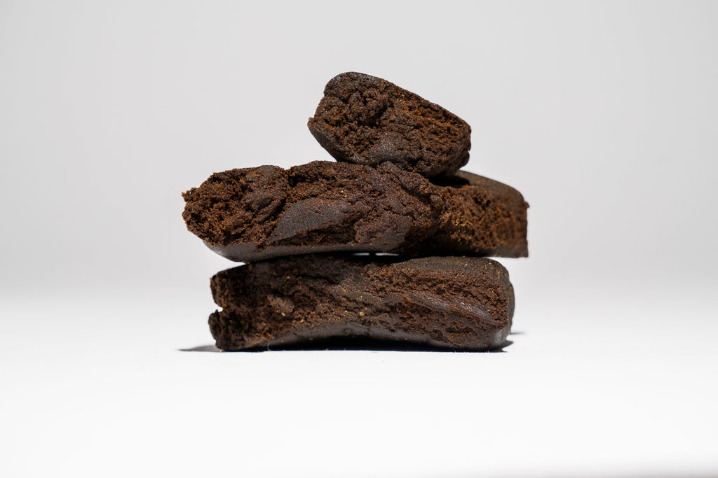 Stack of dark brown hash on a white background