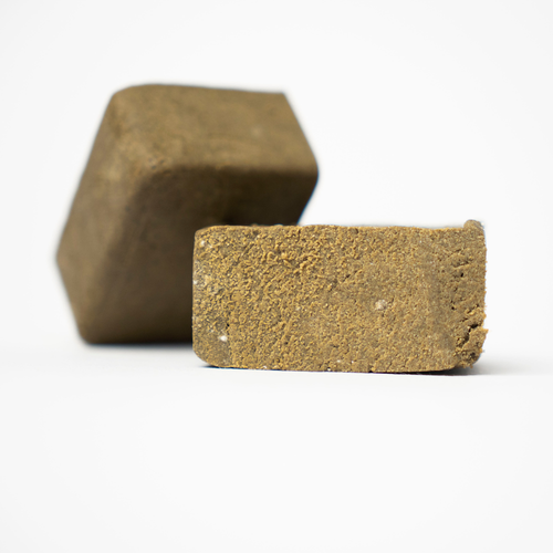 THCA Hash Marocaine Static – dense static hash pieces with sandy interior and refined trichome texture
