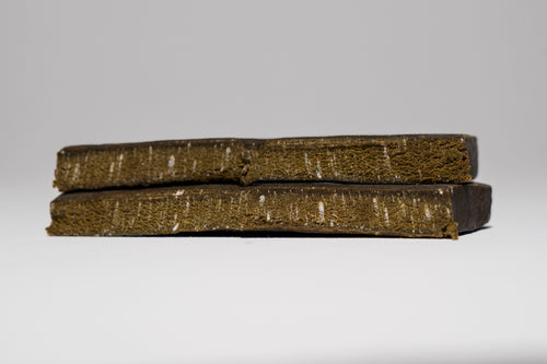 Two stacked green and brown Hash on a gray background