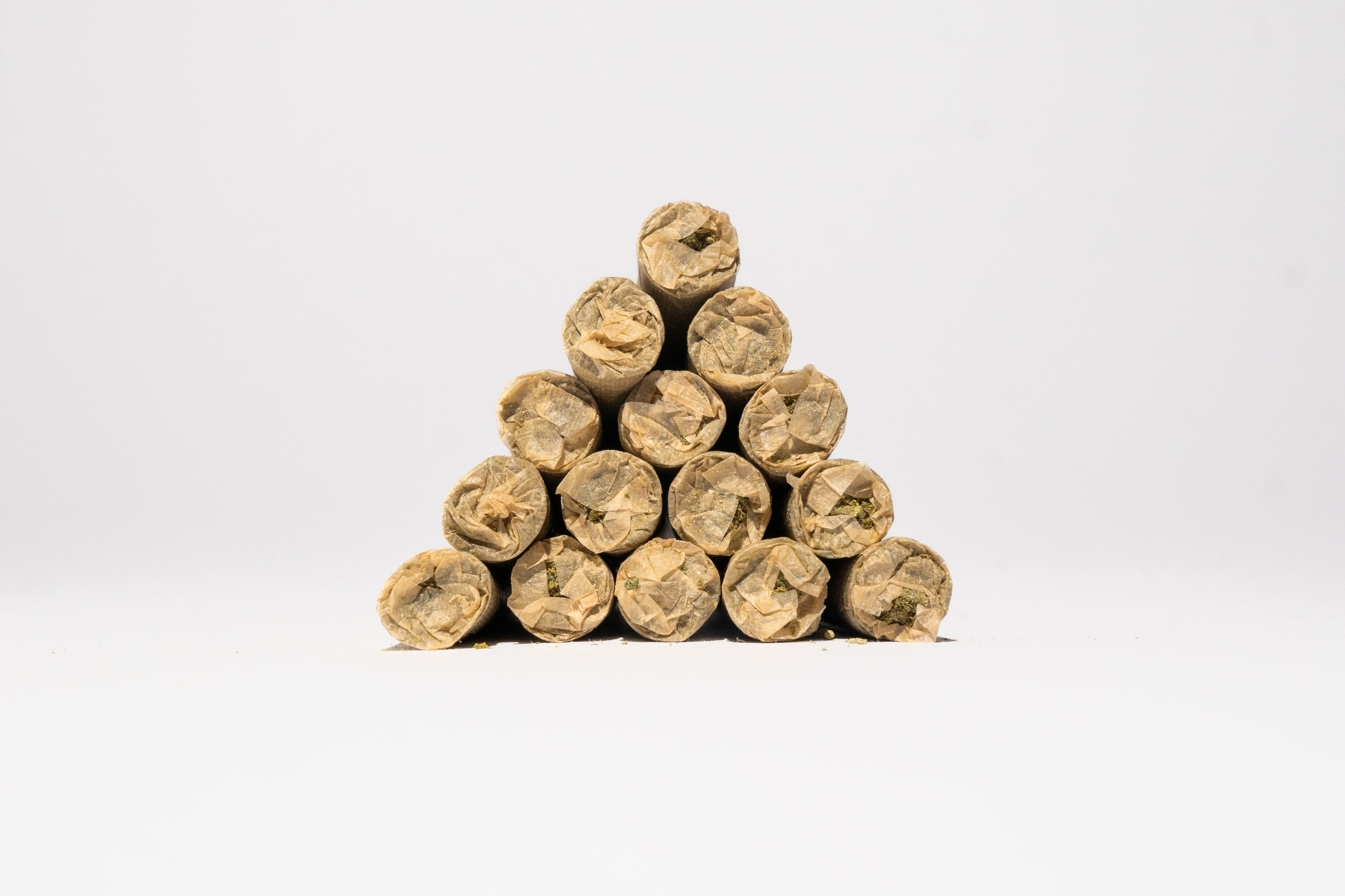 Pyramid of THCa pre rolls on a white background