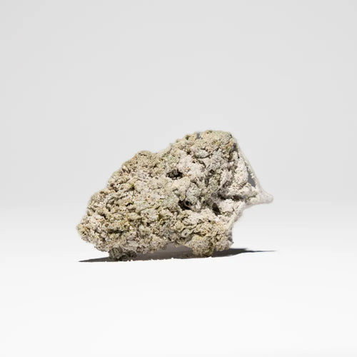 Crystal Kush 25% THCA flower displayed as a compact bud with a pale crystal-covered finish on a clean light background.
