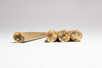 Four rolled joints on a white background